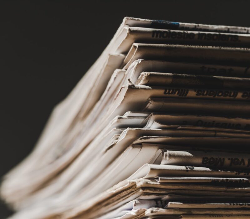 different-print-newspapers-in-pile-isolated-on-bla-2024-11-19-19-06-41-utc